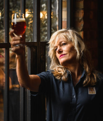 Lotte Peplow inspecting beer